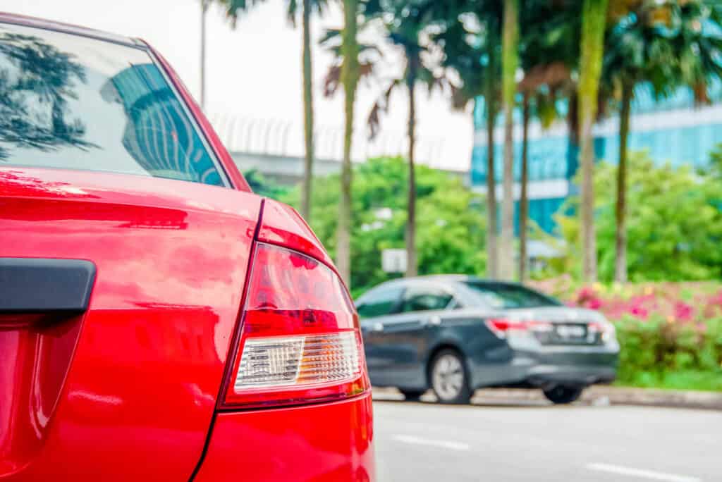 Close up of red car or Singapore road. 