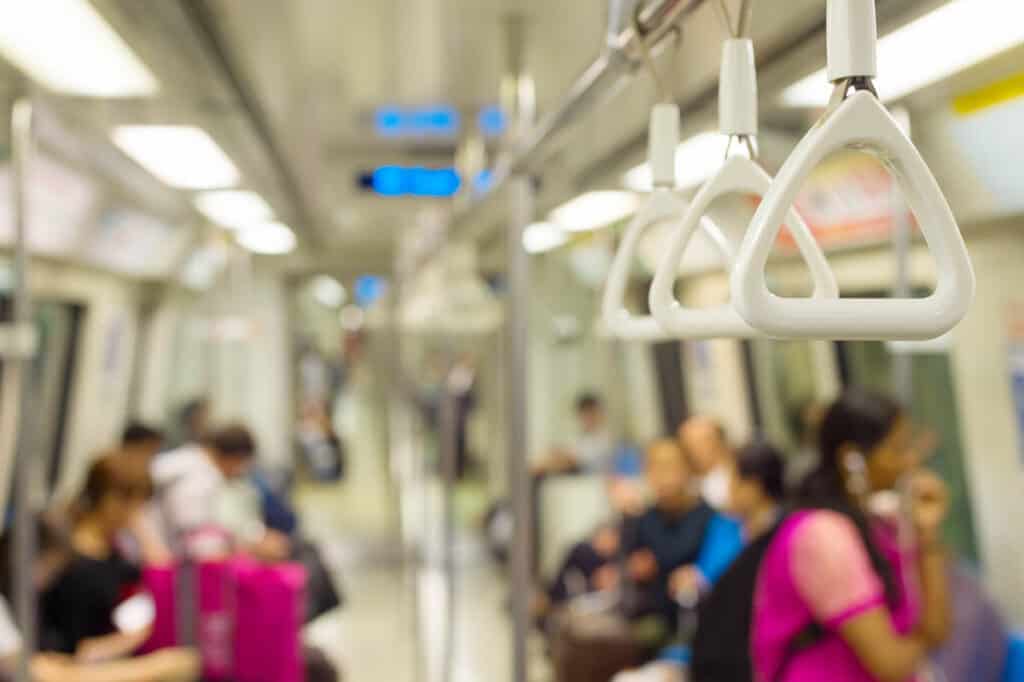 Inside the Singapore MRT. Focus on a handrail.