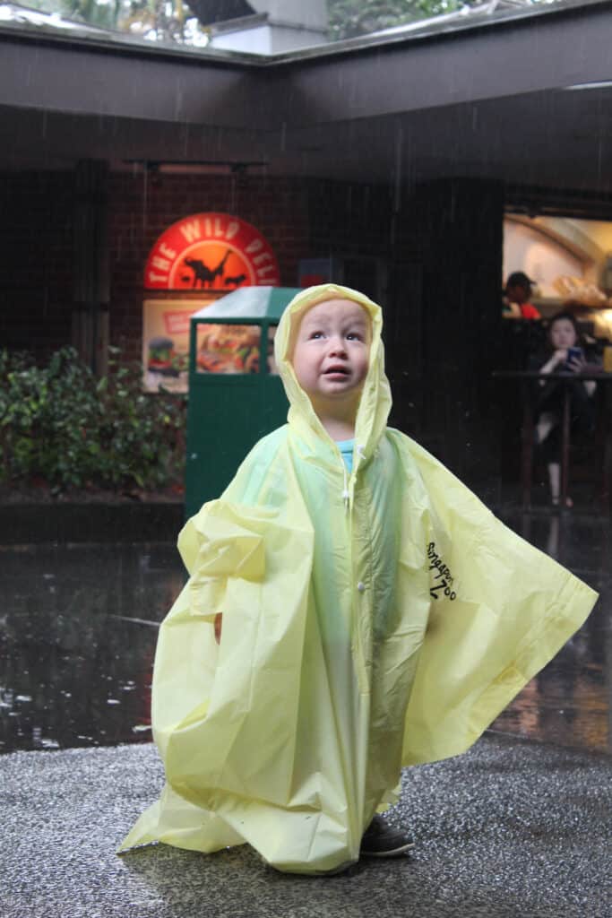 Toddler in a rain poncho in Singapore.