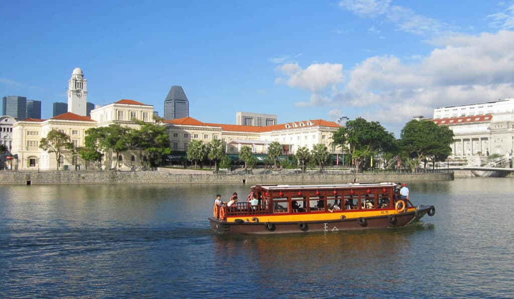 River boat cruise on Singapore River with Museum in background.