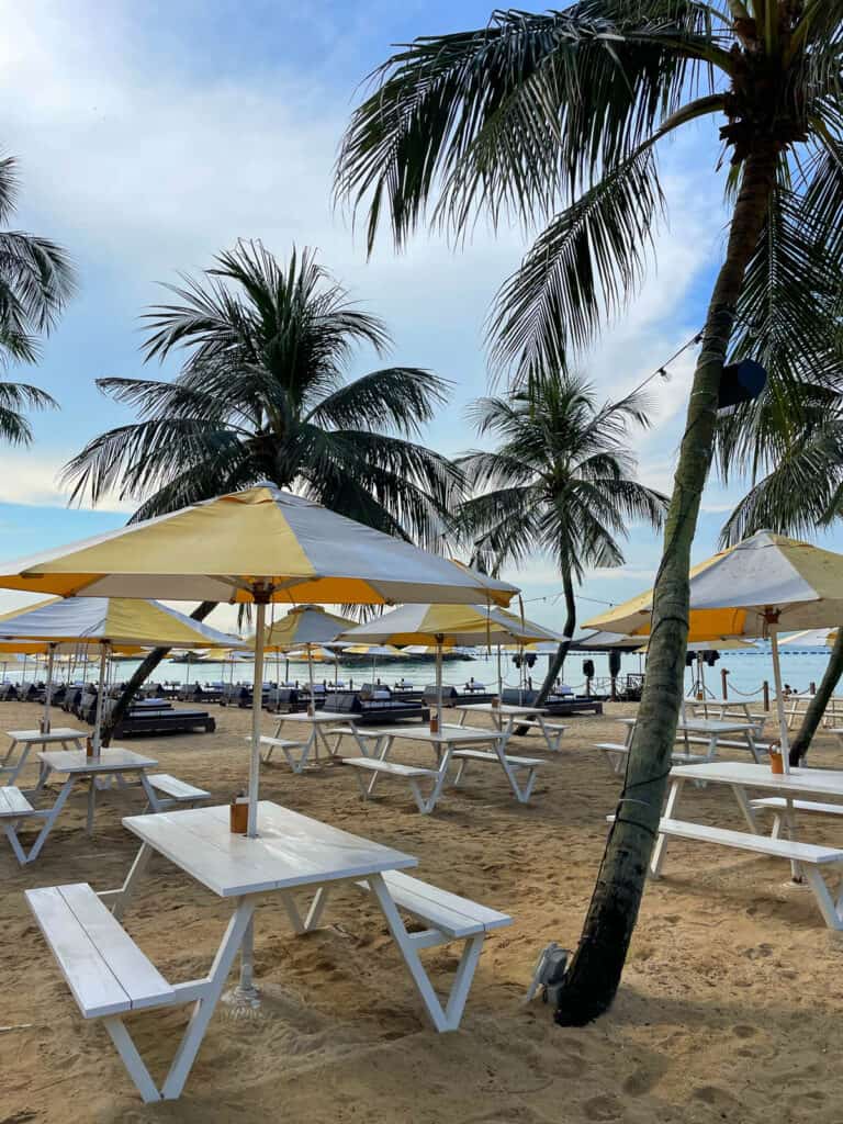 Picnic tables on beach Sentosa Island. 