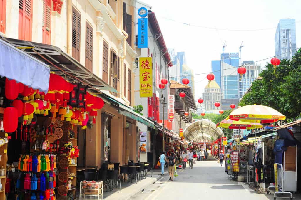 Shoppers walking through Chinatown street in Singapore. 