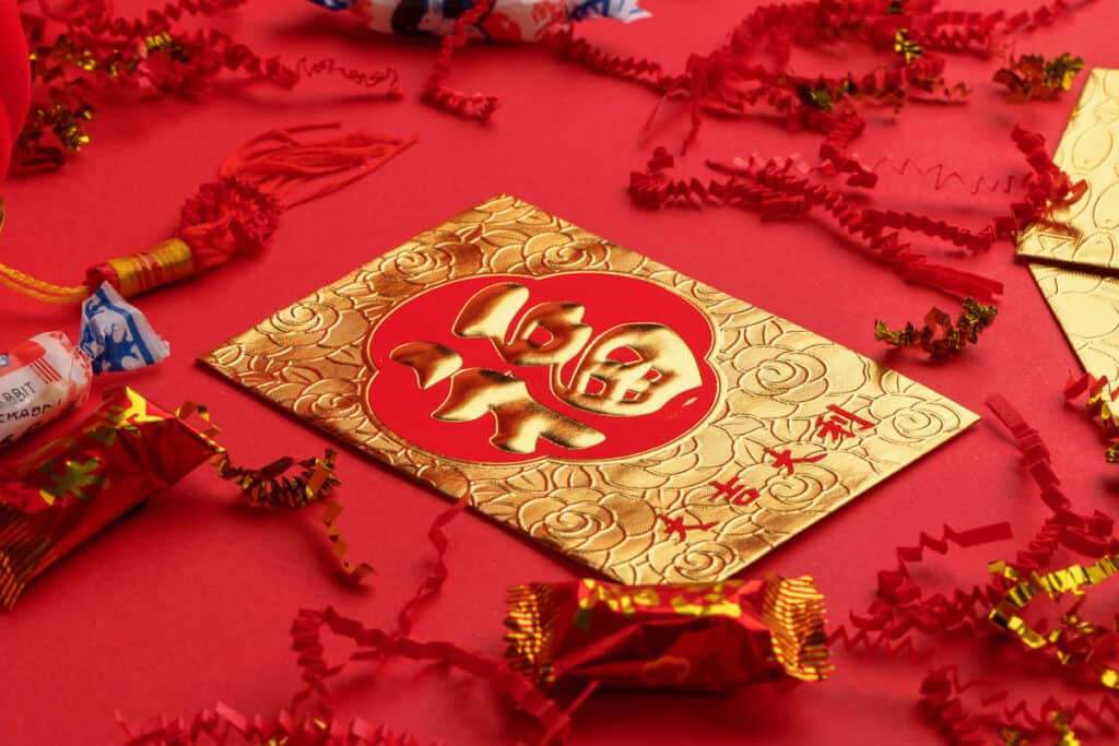 Hong Bao packet on red tablecloth. 