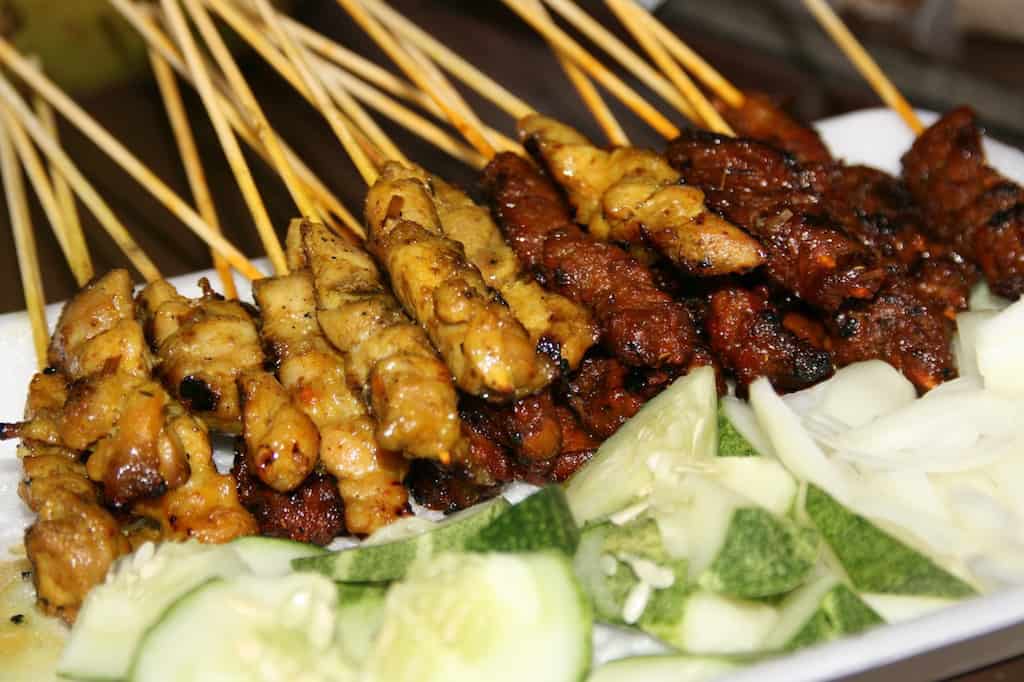 Plate piled up with satay. 
