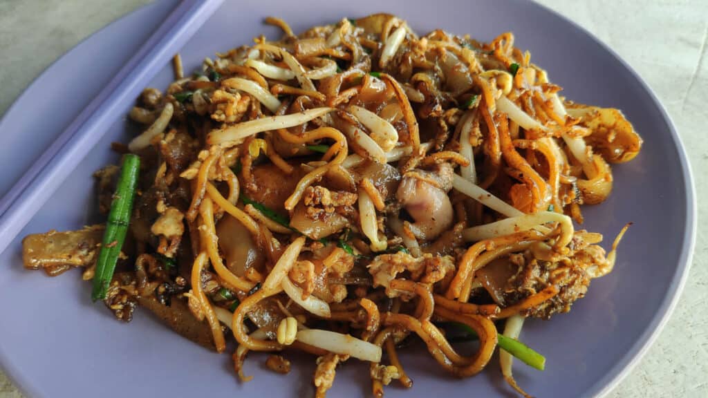 Char Kway Teow on a purple plate. 