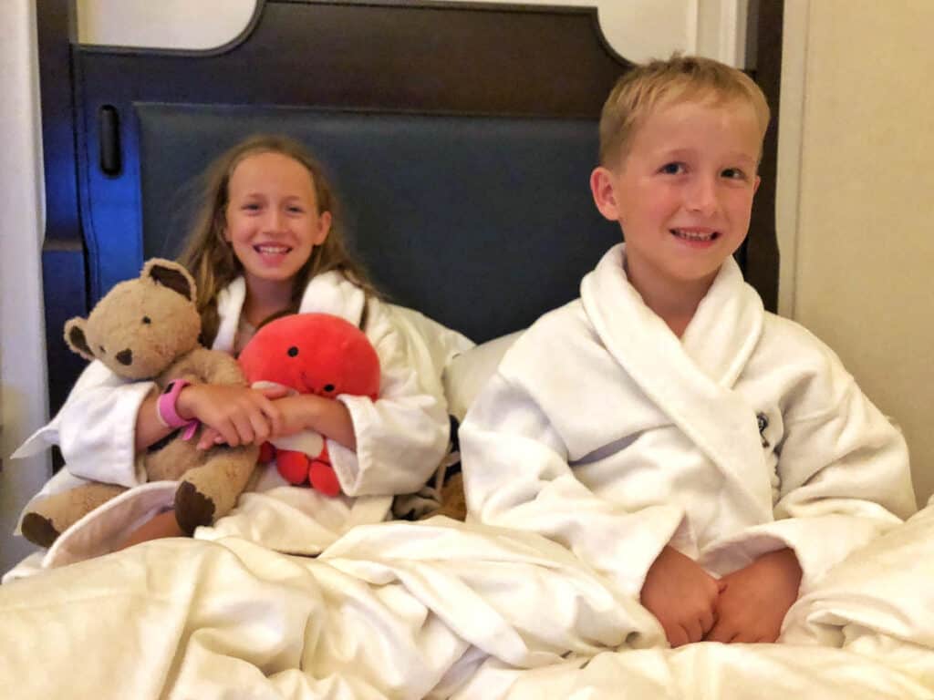Kids in hotel robes in a Singapore hotel room. 