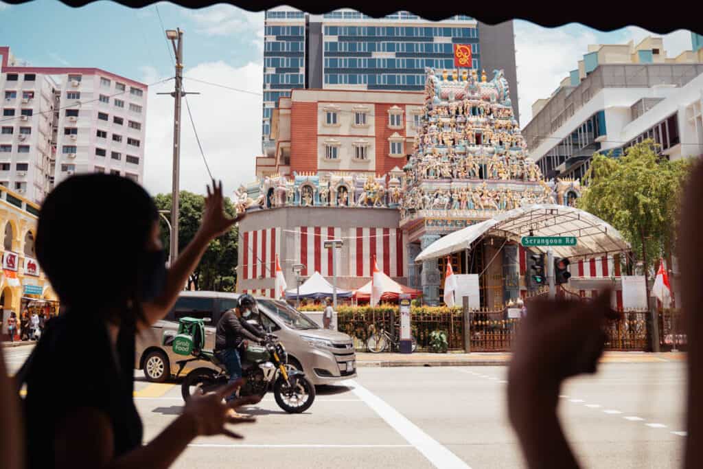 Tour guide showing a temple in Little India. 