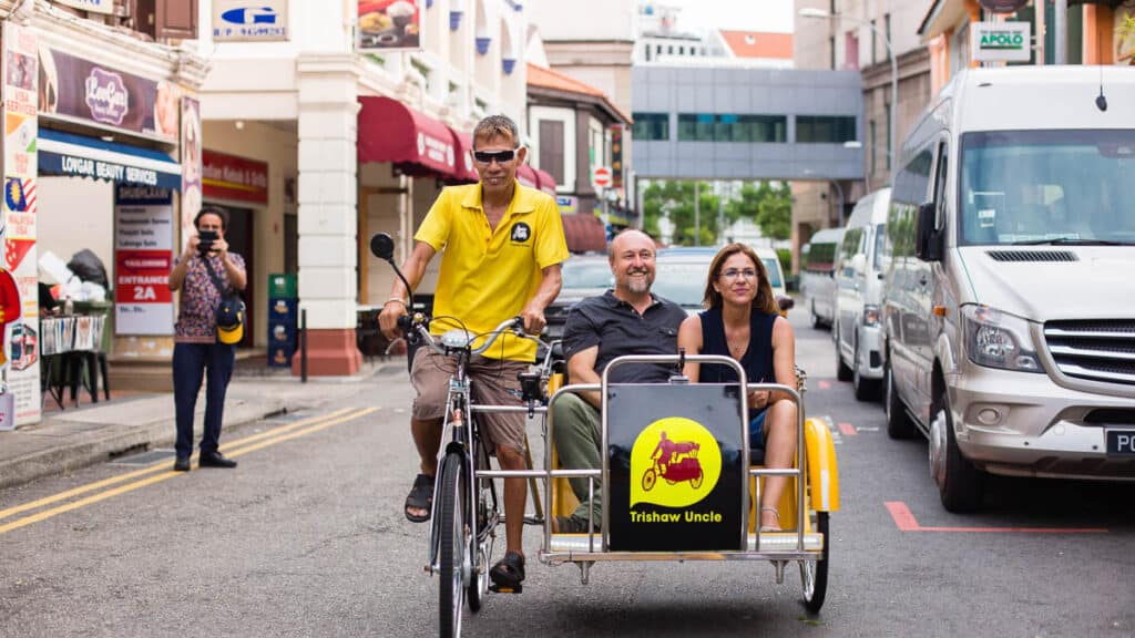 People taking a Trishaw Uncle tour of Singapore.