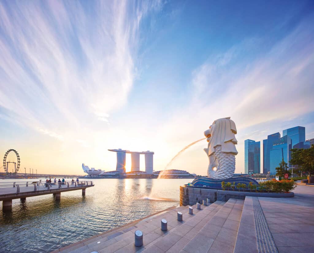 Merlion Singapore with blue sky and Marina Bay Sands in background. 