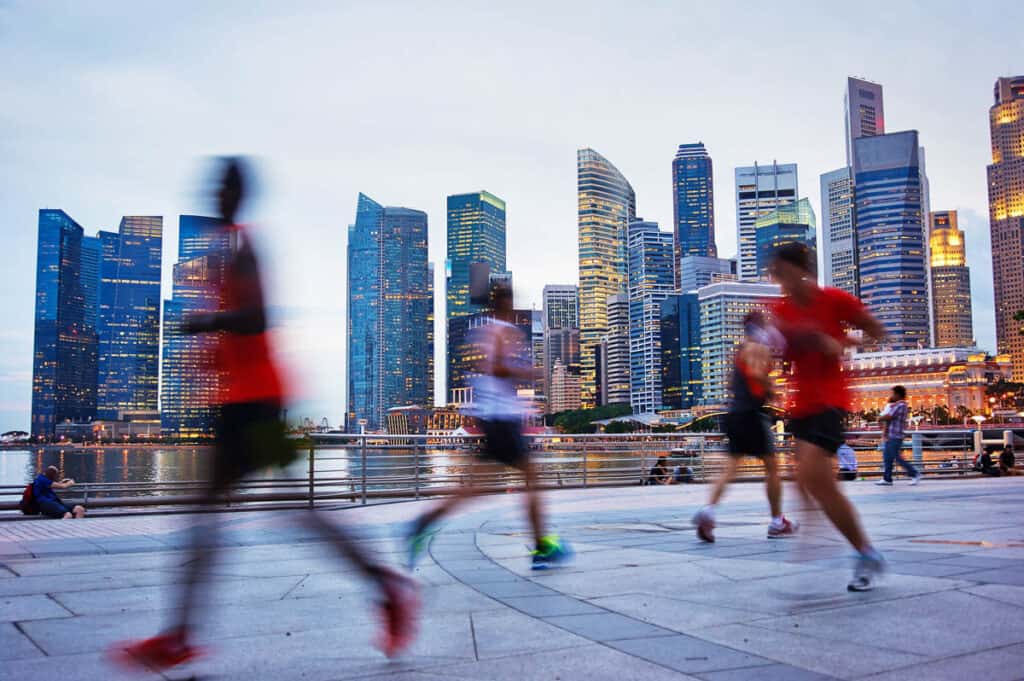 People running with Singapore CBD in background. 