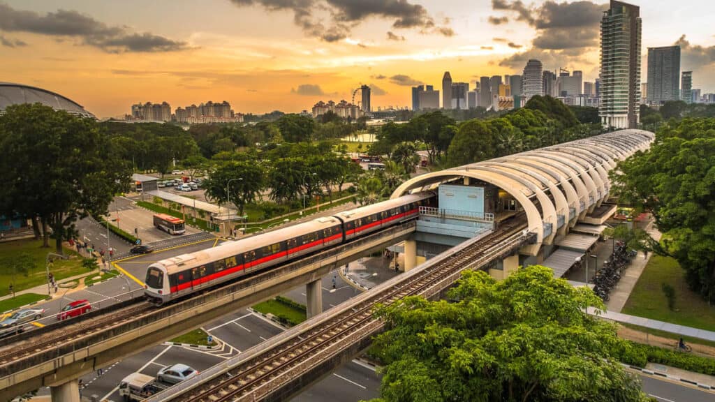 MRT train with view of Singapore behind.