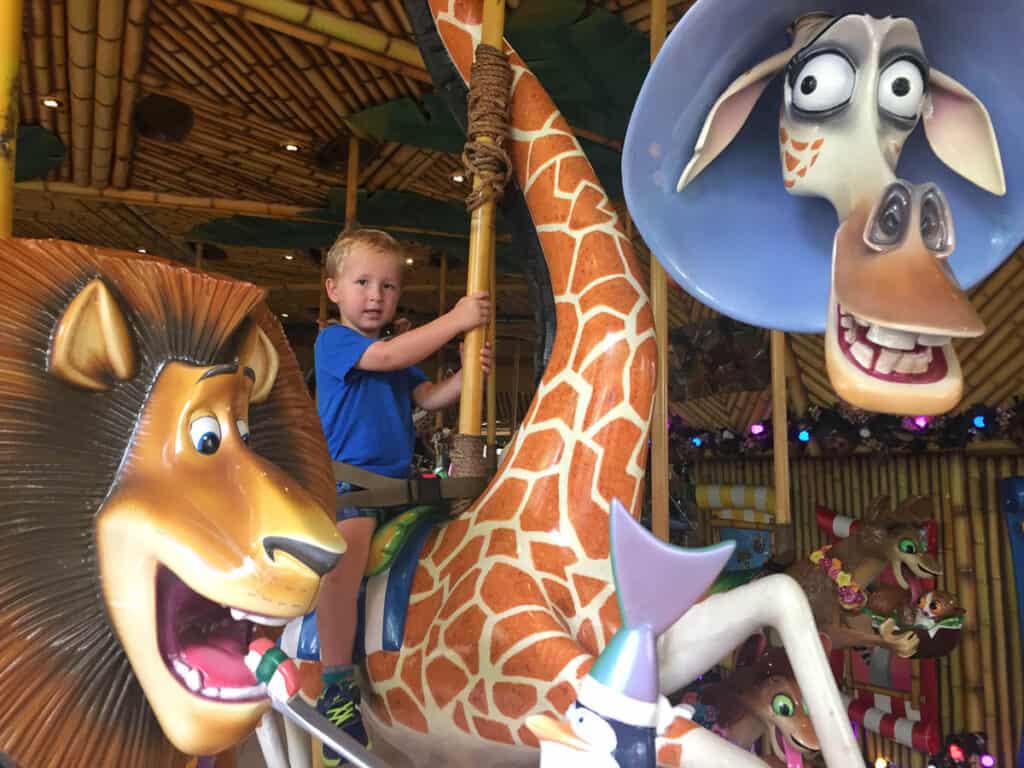 Kid riding carousel at Universal Studios singapore.