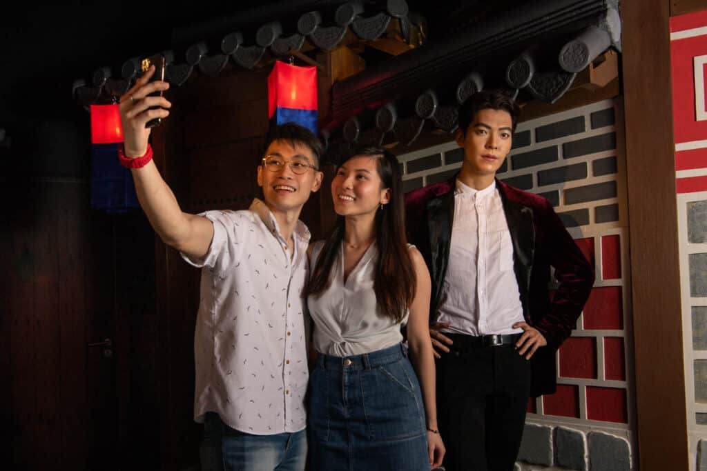 Couple taking a selfie at Madame Tussauds Singapore.