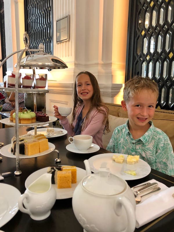 Two kids enjoying Raffles Hotel High Tea. 