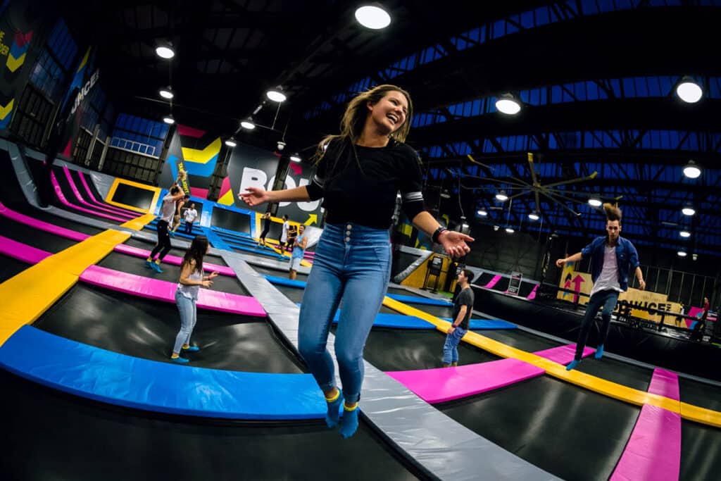 Woman laughing jumping on trampoline at Bounce Singapore.