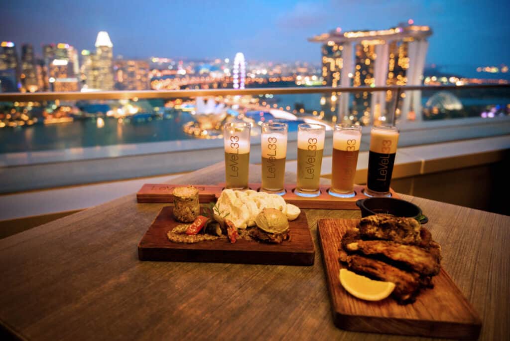 Beers and food at Level 33 with view of Marina Bay in the background. 