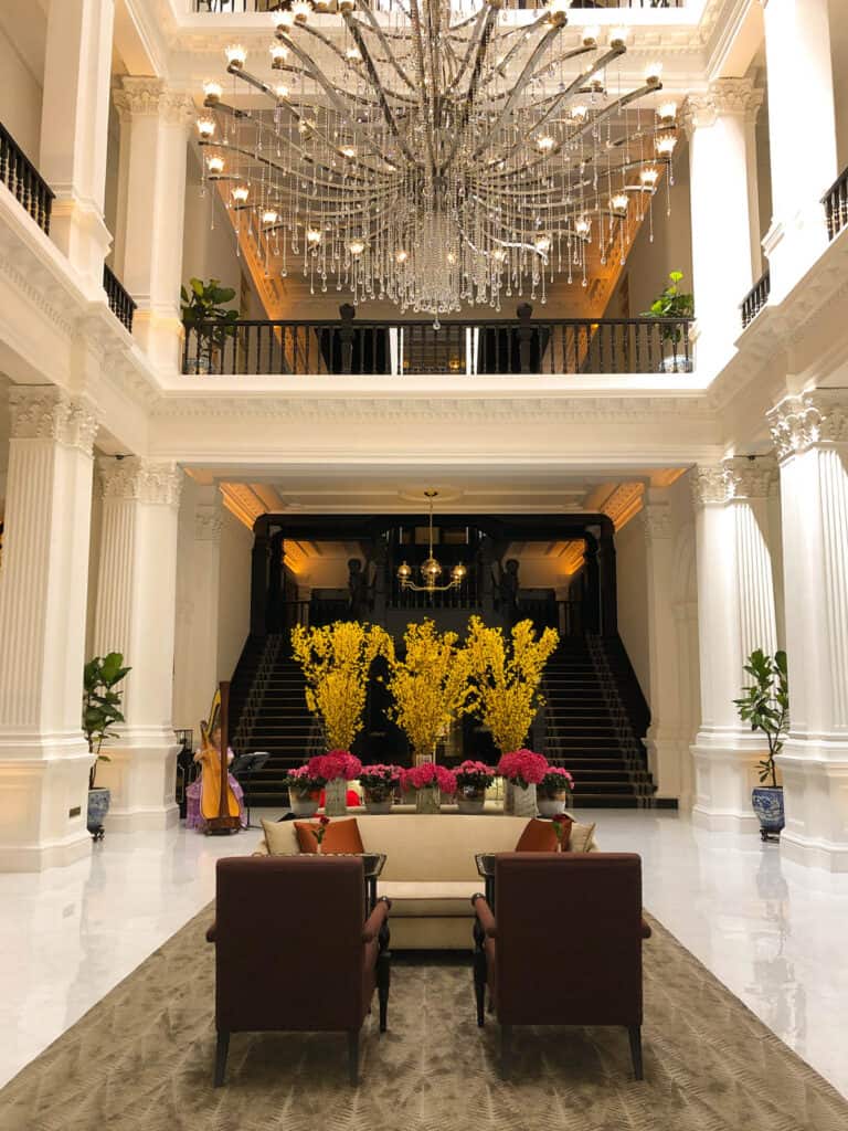 Raffles Hotel Grand Lobby showing pillars and chandelier. 