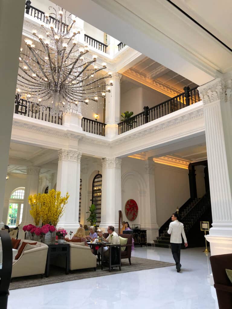 Raffles Hotel Grand Lobby showing pillars and chandelier. 