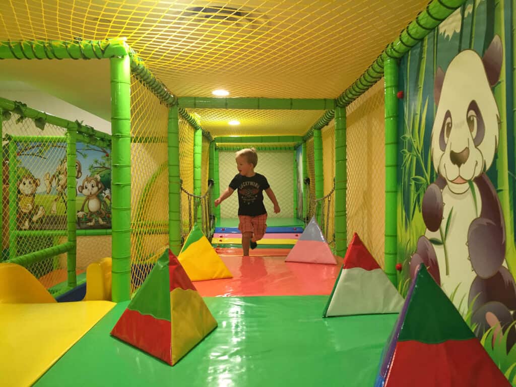 Toddler playing in softplay play gym. 