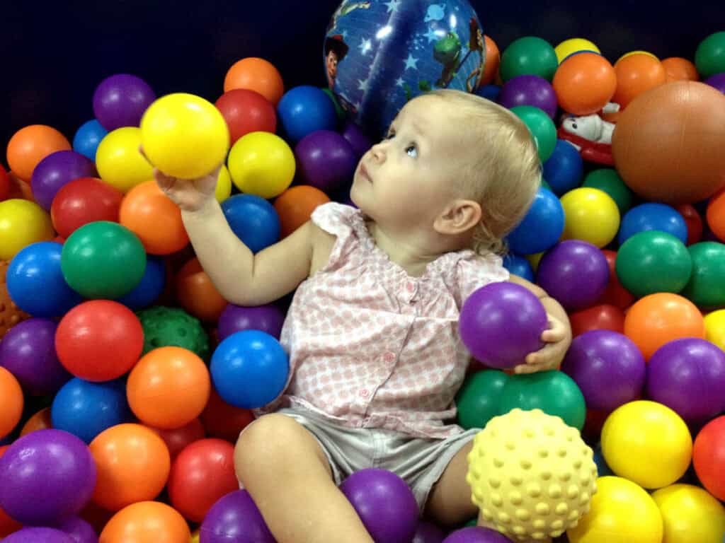 Toddler in ball pit in a Singapore indoor playground. 