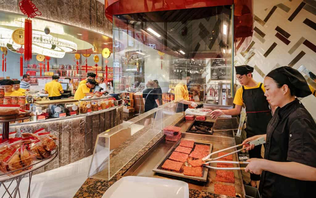 Staff cooking bak kwa at Bee Cheng Hiang.