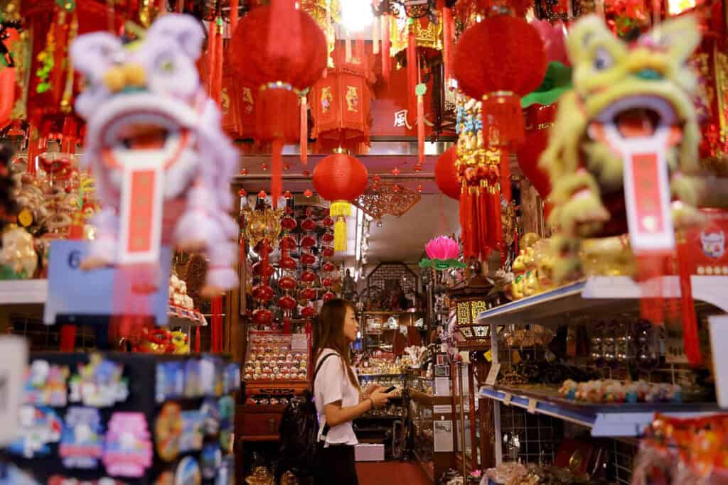 Woman browsing souvenir shop in Chinatown Singapore.