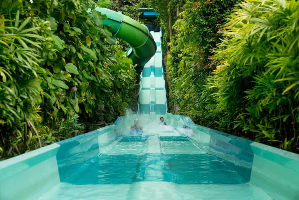 Teenagers in Singapore on a water slide.