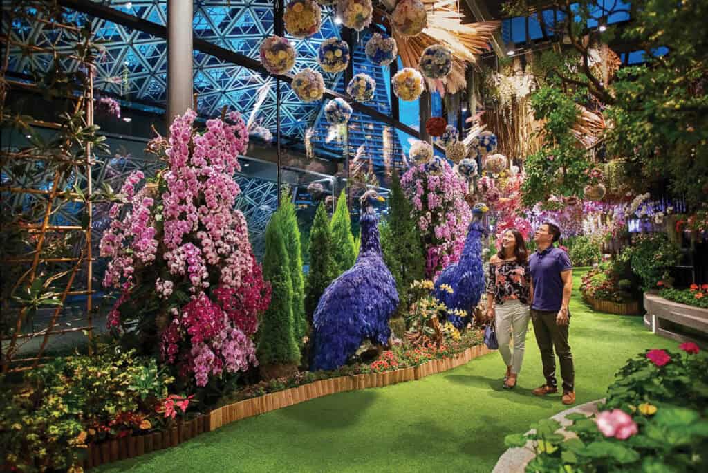 Couple walking through floral fantasy at Gardens by the Bay Singapore.