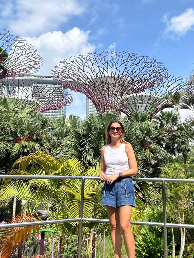 Person posing for photo in front of the supertrees at Gardens by the Bay Singapore.