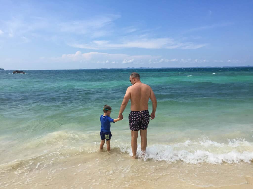 Father and son at the beach in Sibu island Malaysia. 