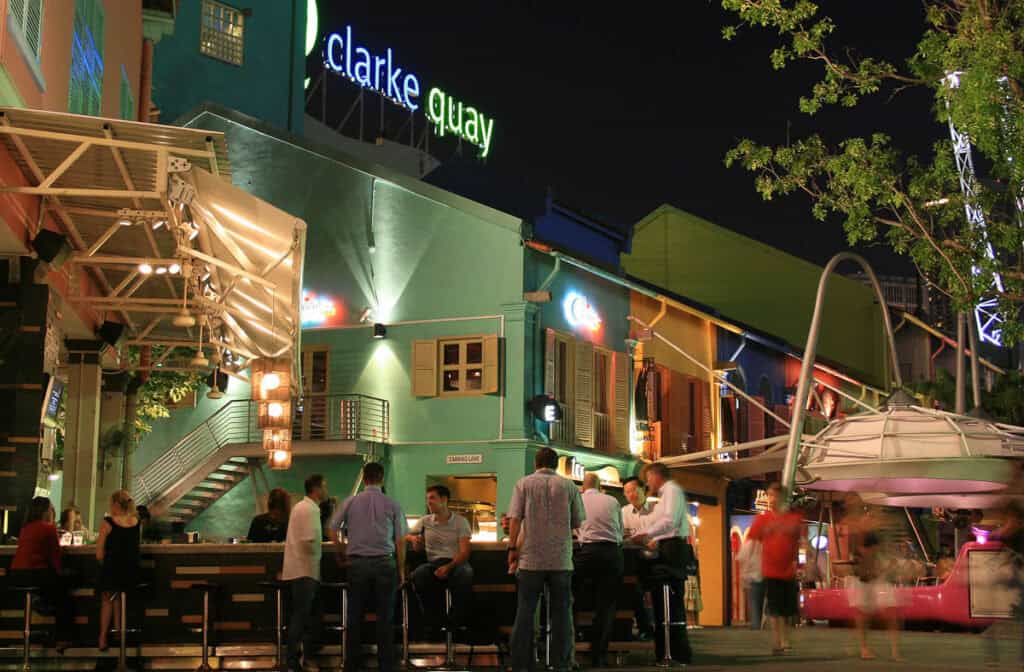 People drinking in an outdoor bar at Clarke Quay.